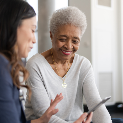 A Medicaid advocate explaining Medicaid services to an elderly woman