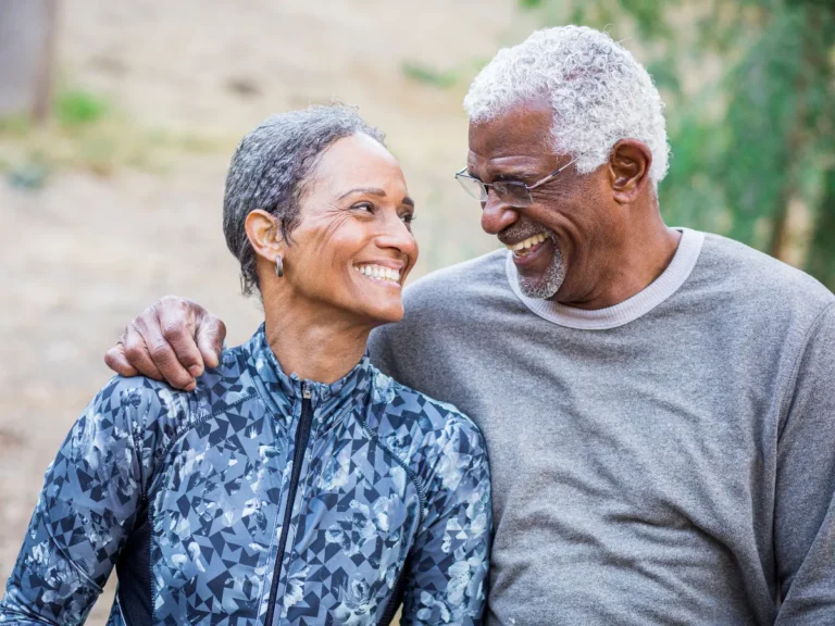 Elderly couple smiling at each other while talking about spousal refusal options