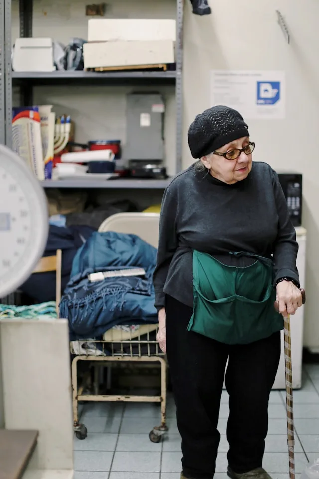 Elderly woman in a physician's room walking with cane