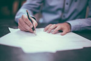 Person filling out a Medicaid spousal refusal form